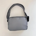 Detail view of the gray nylon fanny pack showing waterproof fabric and adjustable strap - 21*15*6cm / Gray