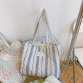 Close-up of quilted floral cotton tote bag with stripes and French label detail - White with Blue Lines & Red Flowers