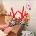 Close-up of festive red reindeer antler hair clips with bows and golden bell details - Red Antlers with Snowflake & Bow Pair