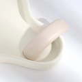 Close-up of beige PU leather hair clip showing detailed texture and elegant pleats - White Leather