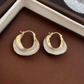 Macro shot of gold-plated oval hoop earrings with pearl accents and minimalist metal design - White Twisted Pleated U-Shape Ear Buckle