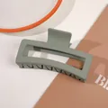 Detail of large sage green matte claw clip with hollow rectangular design on white table - 13cm Rectangular - Matte Forest Green
