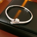Detailed view of silver snake-head cuff bracelet with white mother of pearl inlay - Silver (Real Gold Plated)