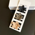Three matte flower hair claws in black, taupe, and beige on a white display card - Coffee Set 2 (3 Pieces)