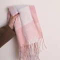 Pink and white plaid faux cashmere scarf with tassels held against a neutral wall - 180*70cm / Light Pink