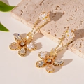 Detailed view of floral stud earrings with cubic zirconia, pearls and cascading tassels - Silver Earring Post - Gold Zircon Inlaid Flower Drop Earrings