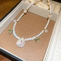 Detailed macro view of a handmade pearl beaded necklace with floral charms and pendants - Titanium Steel Water Drop Pearl Necklace