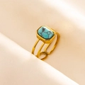 Detail of adjustable gold ring featuring a rectangular turquoise stone on pink satin fabric - Gold-Light Blue Turquoise