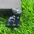 Hand-carved dark blue natural stone cat figurine with polished finish on wood - Blue Sodalite