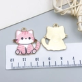 Front and back detail of pink enamel cat pendants showing 3cm size on a ruler scale - 1 Piece / Pink
