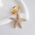 Close-up of golden starfish keychain with sparkling rhinestones and lobster clasp - Basic Starfish / White