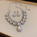 Detailed view of silver necklace and earrings set with brilliant sparkling crystals - Large Clear Diamond Luxury Style / Silver