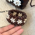 Close-up of vintage ethnic style handcrafted coconut shell beaded flower bracelet - Coffee/Off-white