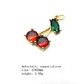 Macro shot of cherry pendant with red and green zircons on polished gold metal base - 4#