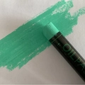 Mint green oil pastel stick showing thick color stroke on white paper surface - Emerald Green