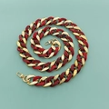Detail of red tortoiseshell resin links joined with gold metal loops and spring clasps - Two-tone Red & Gold