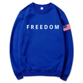 Royal blue unisex hoodie featuring white Freedom text and American flag sleeve patch - Blue