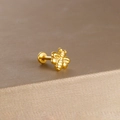 Golden bee stud piercing with detailed wings and flat back on a brushed metal surface - Gold Vintage Little Bee