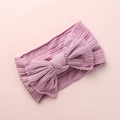 Close-up of baby nylon headband with knit jacquard bow and textured ribbed fabric pattern - Taro Purple
