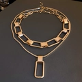 Detail showing gold double-layered necklace with chunky chain and rectangular pendant - Double Layer Set / Gold