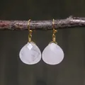 Detail of rose quartz teardrop earrings with handmade gold wire wrapping on wood - Light Pink Rose Quartz Faceted Style (ER1060-4)