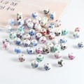 Polished round ceramic beads featuring colorful floral patterns for DIY jewelry - 8mm Mixed Decal Colors