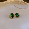Macro shot of oval emerald green earrings with shimmering white rhinestones and gold base - 24# Green Double Circle Studs