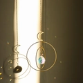 Golden moon crystal suncatcher with metal rings and faceted ball creating rainbows - Design No.16