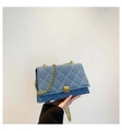 Close-up of blue denim quilted square bag with gold chain strap and lock detail - Light Blue