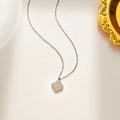 Silver four-leaf clover pendant necklace with cross-star pattern on white surface - Silver Necklace