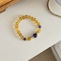 Detailed macro view of natural yellow and purple crystal bead bracelet with gold spacers - Citrine & Amethyst Bracelet