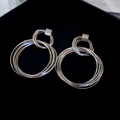 Makroaufnahme silberner mehrlagiger Creolen mit runden Metallringen im Vintage-Stil - 34# Stahlstift - Silberne Mehrlagige Runde Hohl-Ohrstecker