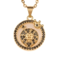 Detail of gold lion pendant with crown, black stones, and mother of pearl inlay - Leo