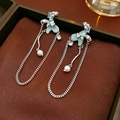 Close-up of long tassel earrings with light green floral stones and white pearls - Silver Earring Post - Green Tassel Pearl