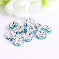 Detailed view of silver rondelle spacer beads with light blue rhinestones for DIY jewelry - Silver Plated Lake Blue