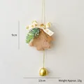 Brown plush Christmas ornament with heart bow, pine needles and a golden bell - Light Coffee