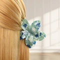 Detail of blue marble floral hair claw clip worn on blonde hair for a secure hold - Style A Flower (Blue-Green Marble)