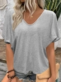 Detailed close-up of grey V-neck T-shirt with batwing sleeves and textured cotton fabric - Gray