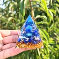 Handmade resin pyramid ornament with blue crystal sphere and gold flakes on green background - Style 67