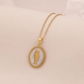 Detailed close-up of golden fish pendant on white enamel base with mother of pearl finish - Oval Case White