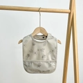 Waterproof cream baby bib with grey floral pattern and silicone food catcher pocket - Wild Berry Floral