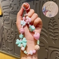 Pastel pink and green beaded phone charm with bow, heart, and flower charms - Green - Dopamine Phone Chain