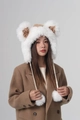 Detailed view of white faux fur winter bucket hat with brown ears and warm fluffy pom poms - White