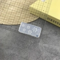 Detailed view of 3D silicone nail mold with rose patterns on a scale for size measurement - #168 Large and Small Flowers