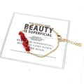 Macro detail of irregular red stone beads and adjustable gold chain with lobster clasp - Red Coral