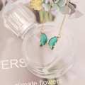 Elegant gold butterfly necklace with green translucent wings and sparkling white crystals - Light Green