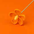 Close-up of handmade crochet flower with orange petals and yellow core on stems - Cute Four Violet Flower Branches - Orange