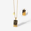 Golden Taurus zodiac necklace featuring a tarot-style pendant and a circular symbol tag - Taurus