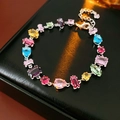 Detail of silver bracelet with multi-colored teardrop and square zircon gemstones - Multicolor