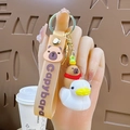 Cute Capybara keychain with a brown strap featuring the animal sitting on a white duck - Capybara Riding Seagull